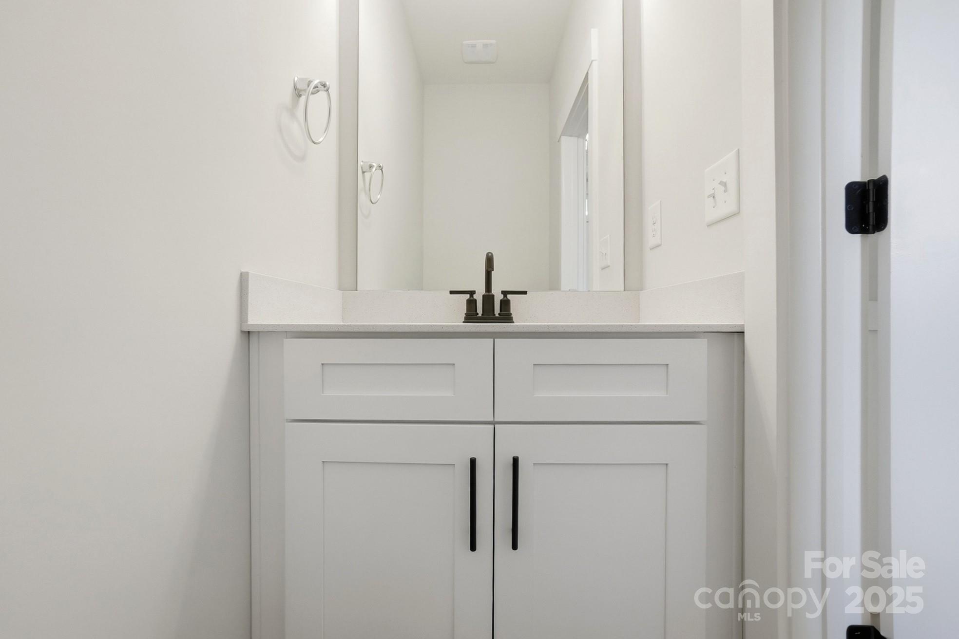 111 Viburnum Road Waxhaw, NC 28173 - Photo 15 of 39 a bathroom with a sink and mirror