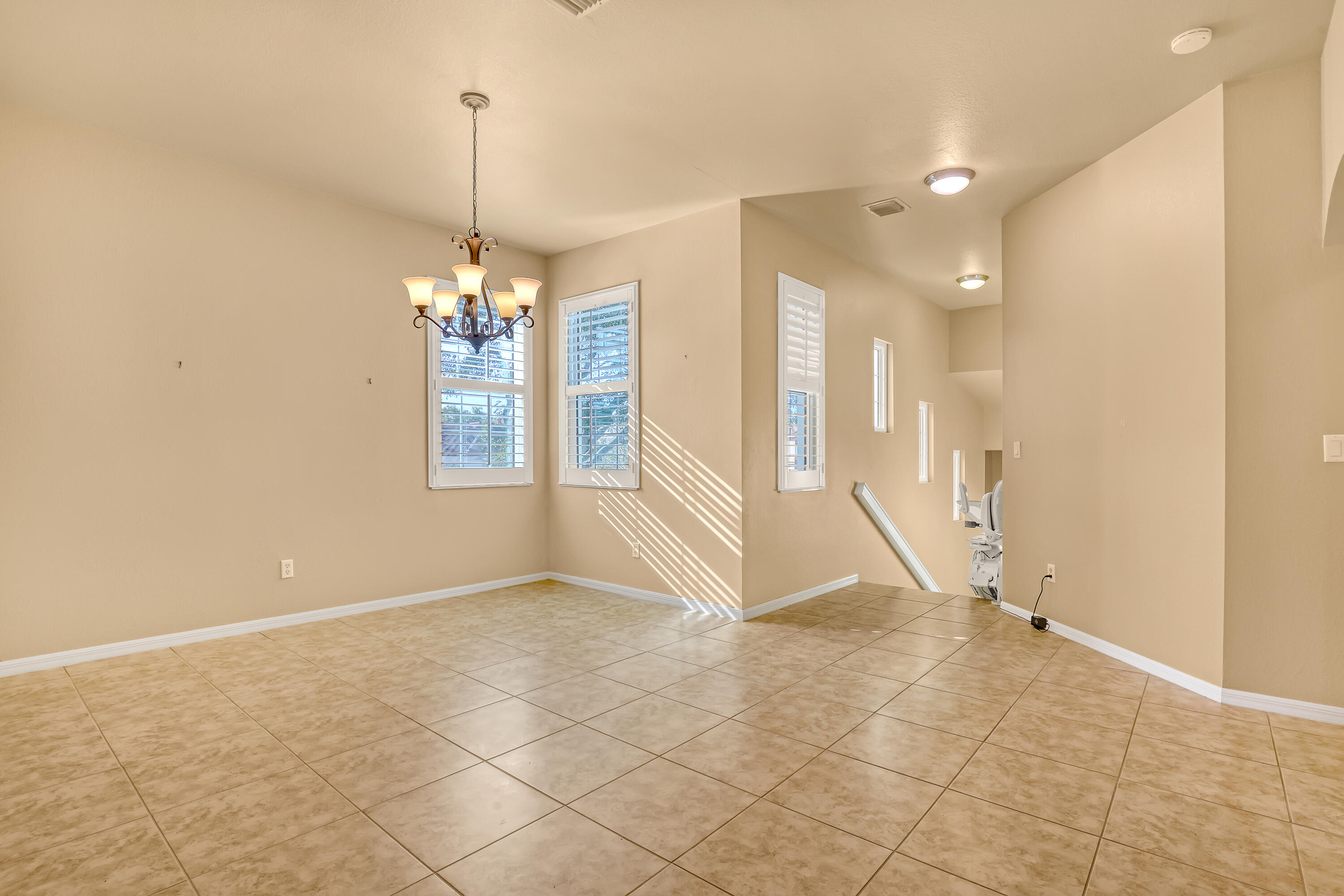 2136 Wingate Bend Wellington, FL 33414 - Photo 13 of 44 a view of a livingroom with a chandelier fan and windows