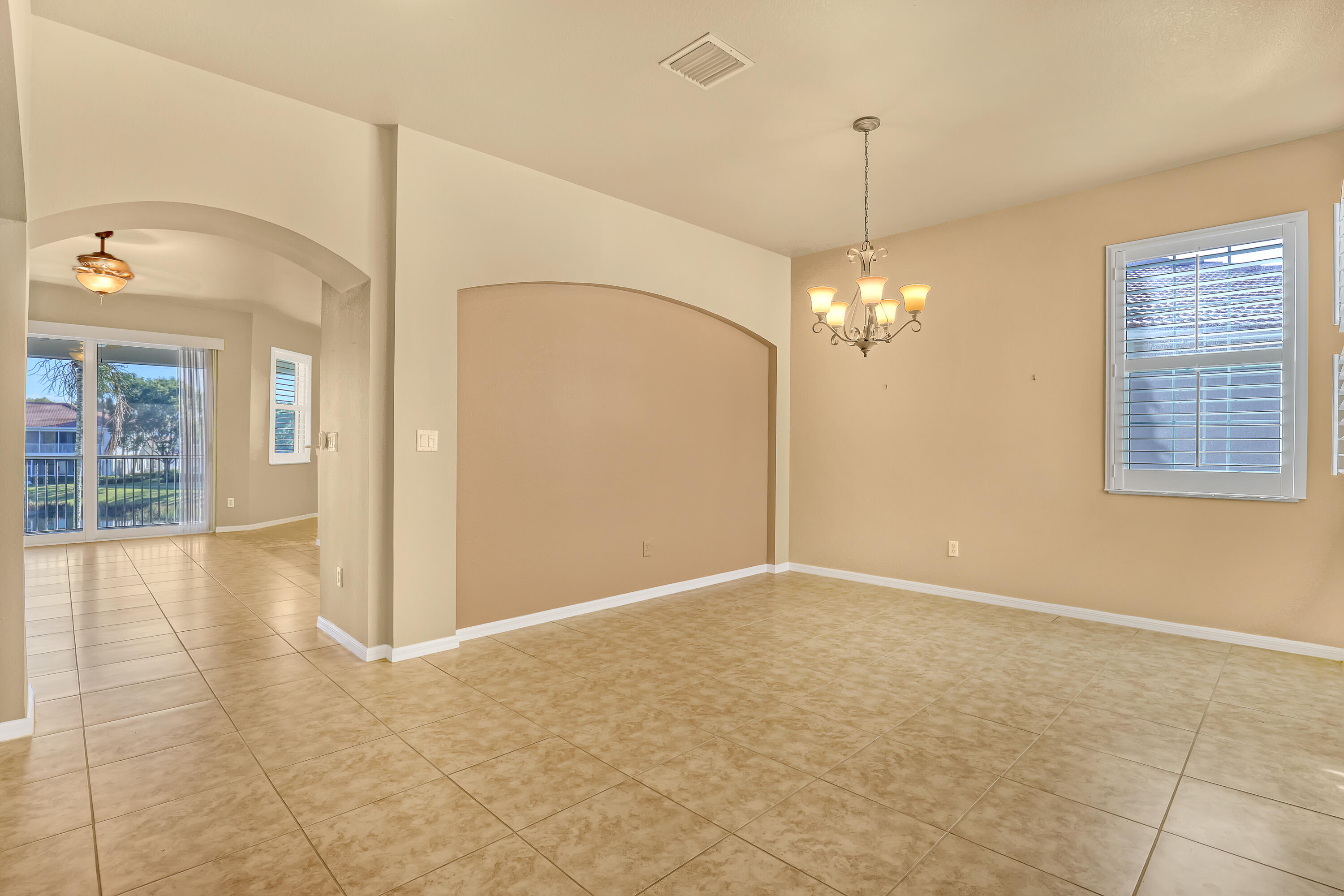 2136 Wingate Bend Wellington, FL 33414 - Photo 15 of 44 a view of a room with window and chandelier