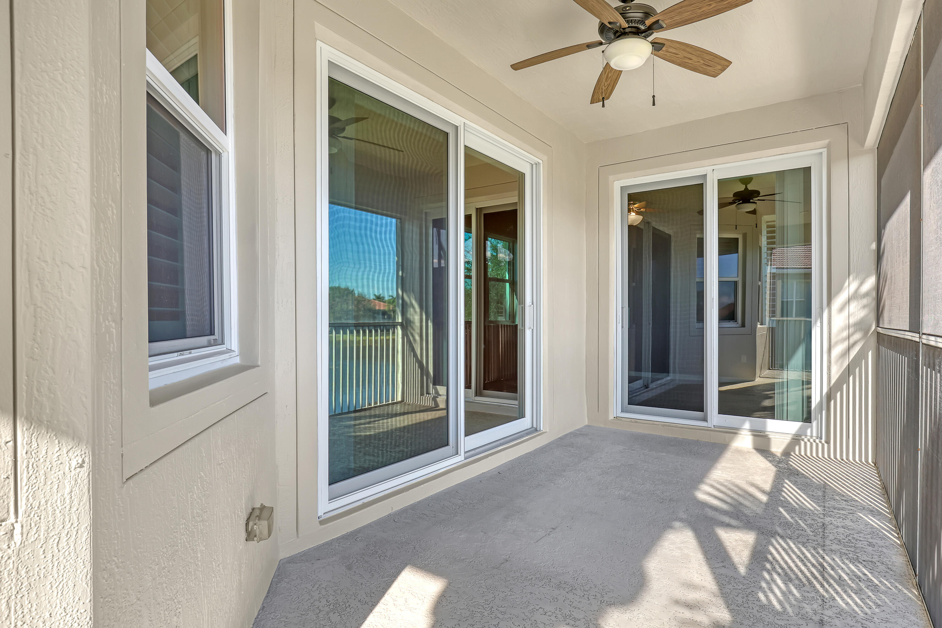 2136 Wingate Bend Wellington, FL 33414 - Photo 30 of 44 a view of a livingroom with a ceiling fan and window