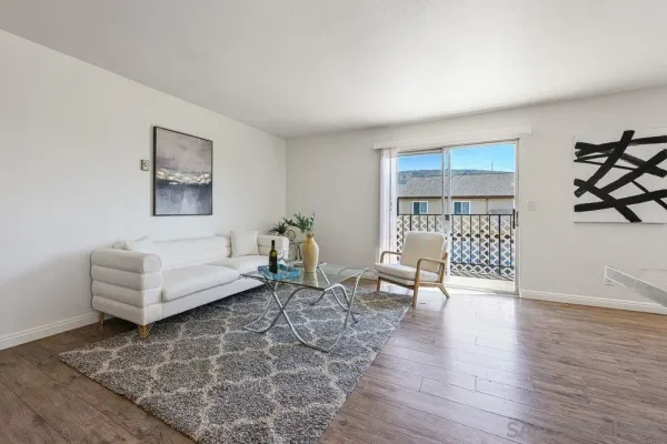 a living room with furniture and wooden floor