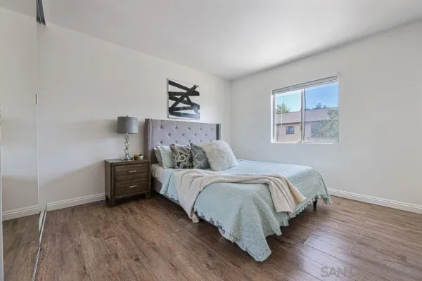 a bed room with a bed and a night stand