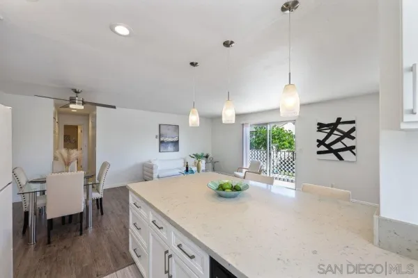 a view of a kitchen with kitchen island and stainless steel appliances