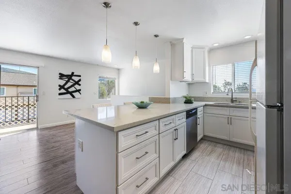 a kitchen with a sink window and cabinets