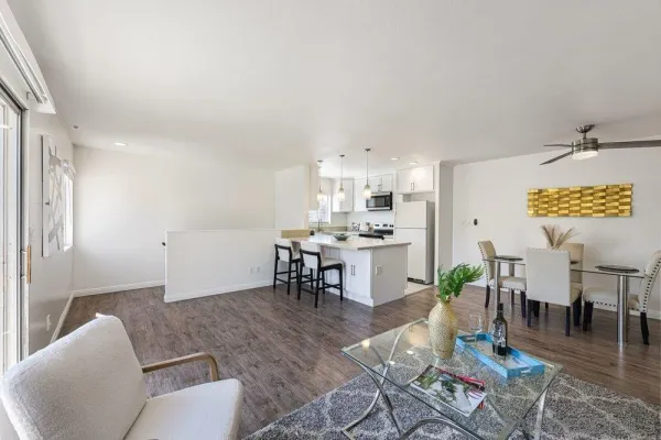 a living room with furniture and kitchen view