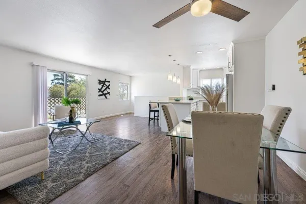 a living room with furniture wooden floor and a chandelier