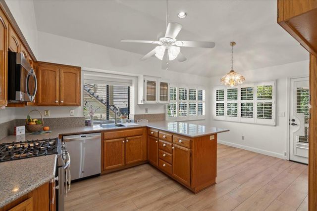 a kitchen with lots of counter top space and wooden floor