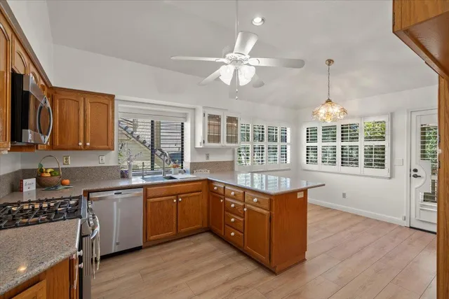 a kitchen with lots of counter top space and wooden floor