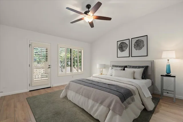 a bedroom with a bed and a large window