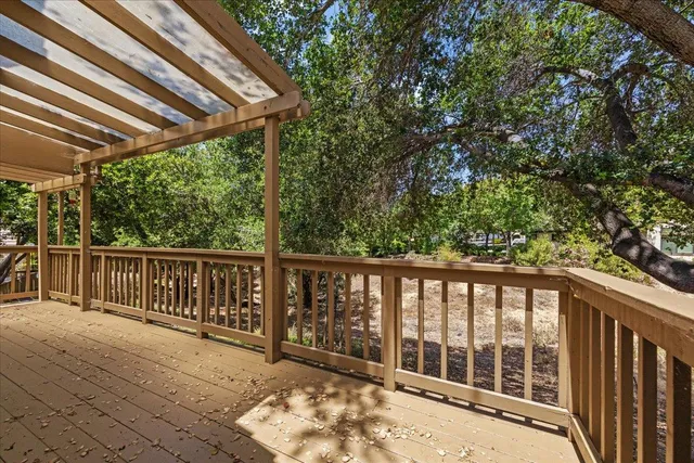 a view of a wooden deck next to a yard