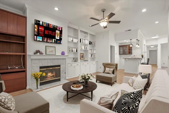 a living room with furniture fireplace and flat screen tv