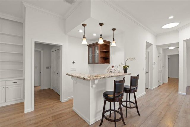 a dining room with furniture and wooden floor
