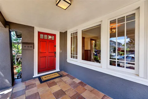 a living room with patio furniture and a wooden floor
