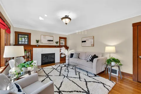 a view of a dining room with furniture wooden floor and a potted plant