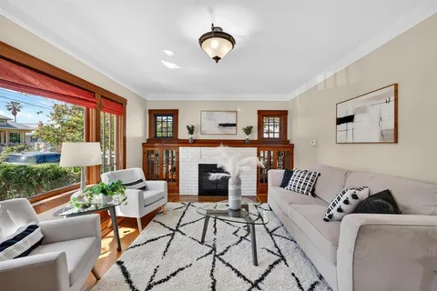 a view of a dining room with furniture large windows and wooden floor