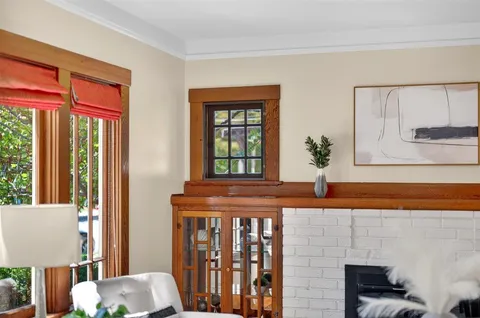 a kitchen that has a stove and a wooden floor