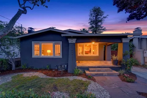 a view of a house with backyard sitting area and garden