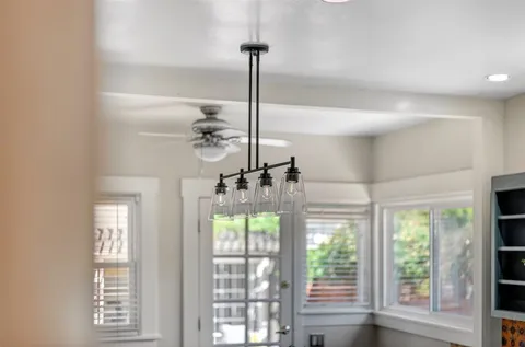 a bedroom with a bed and a lamp on dresser