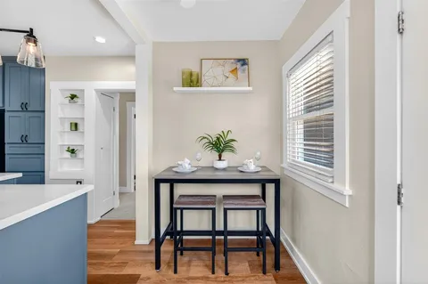 a bedroom with a bed window and a chandelier