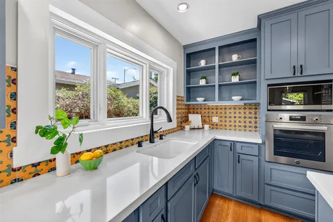 a view of a house with swimming pool and sitting area