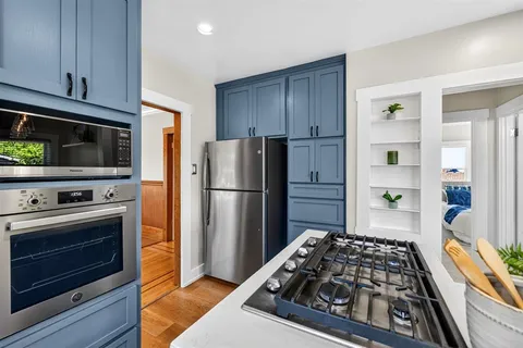 a view of a house with backyard sitting area and garden
