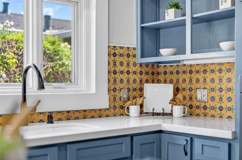 a view of a house with sitting area and garden