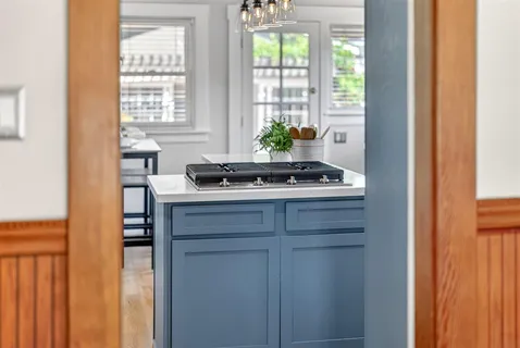 a view of a patio with table and chairs potted plants and large tree