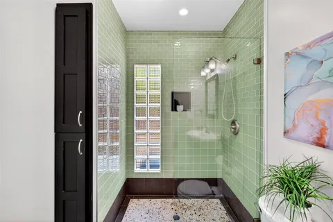 a living room with furniture large window and wooden floor