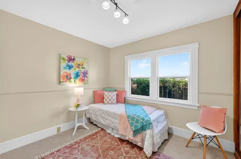 an aerial view of a house with a yard and potted plants