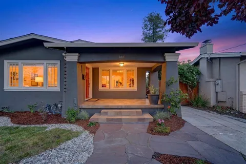 a living room with furniture a fireplace and a table
