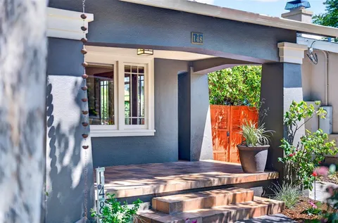 a living room with furniture a fireplace and a potted plant