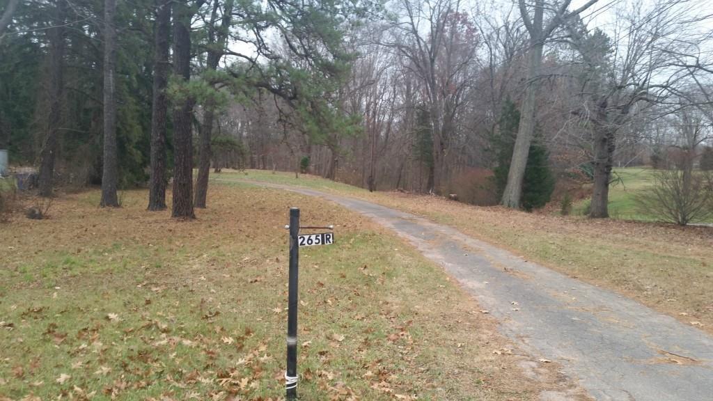 265 R Scantic Road East Windsor, CT 06088 - Photo 1 of 1 a backyard of a house with large trees and wooden fence