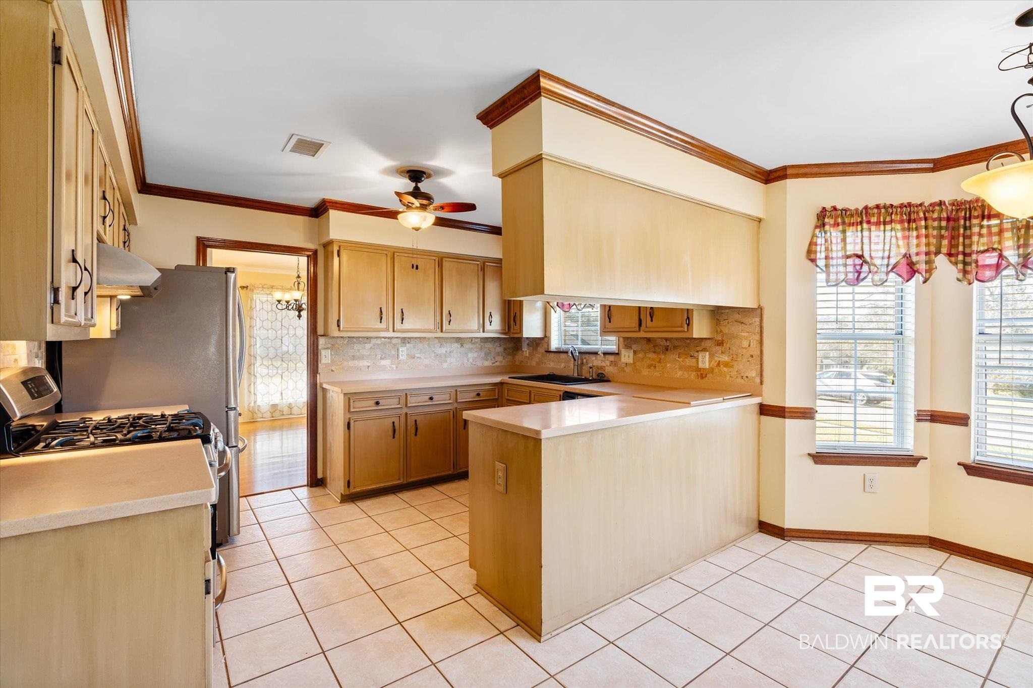 7200 Pine Station Road South Mobile, AL 36695 - Photo 6 of 29 Kitchen with kitchen peninsula, ceiling fan, sink, exhaust hood, and light tile patterned floors