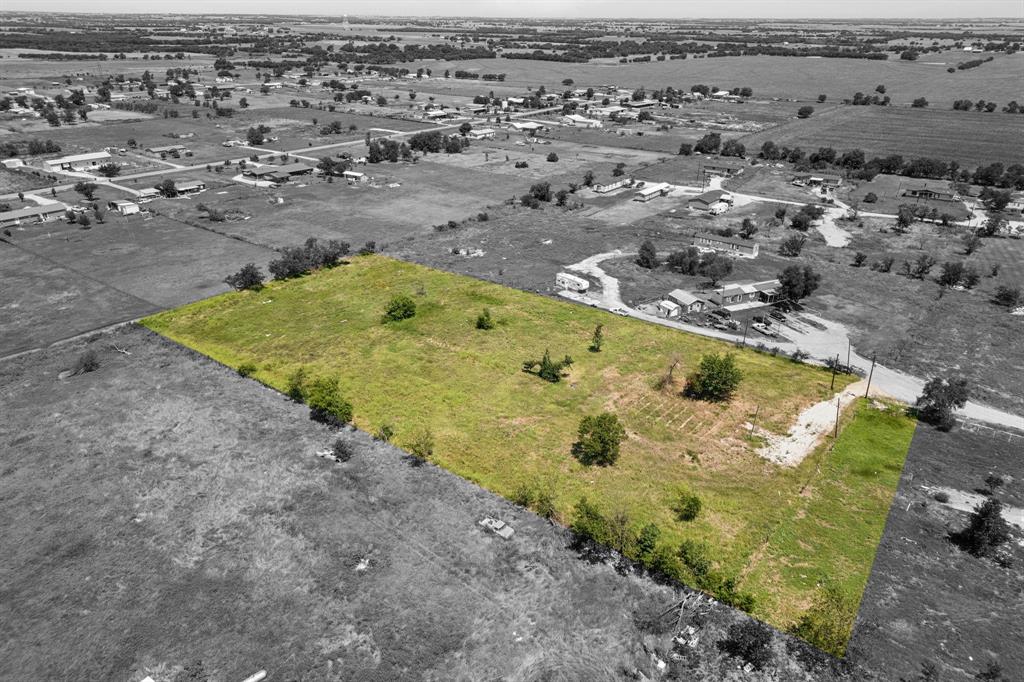 an aerial view of a swimming pool with a yard