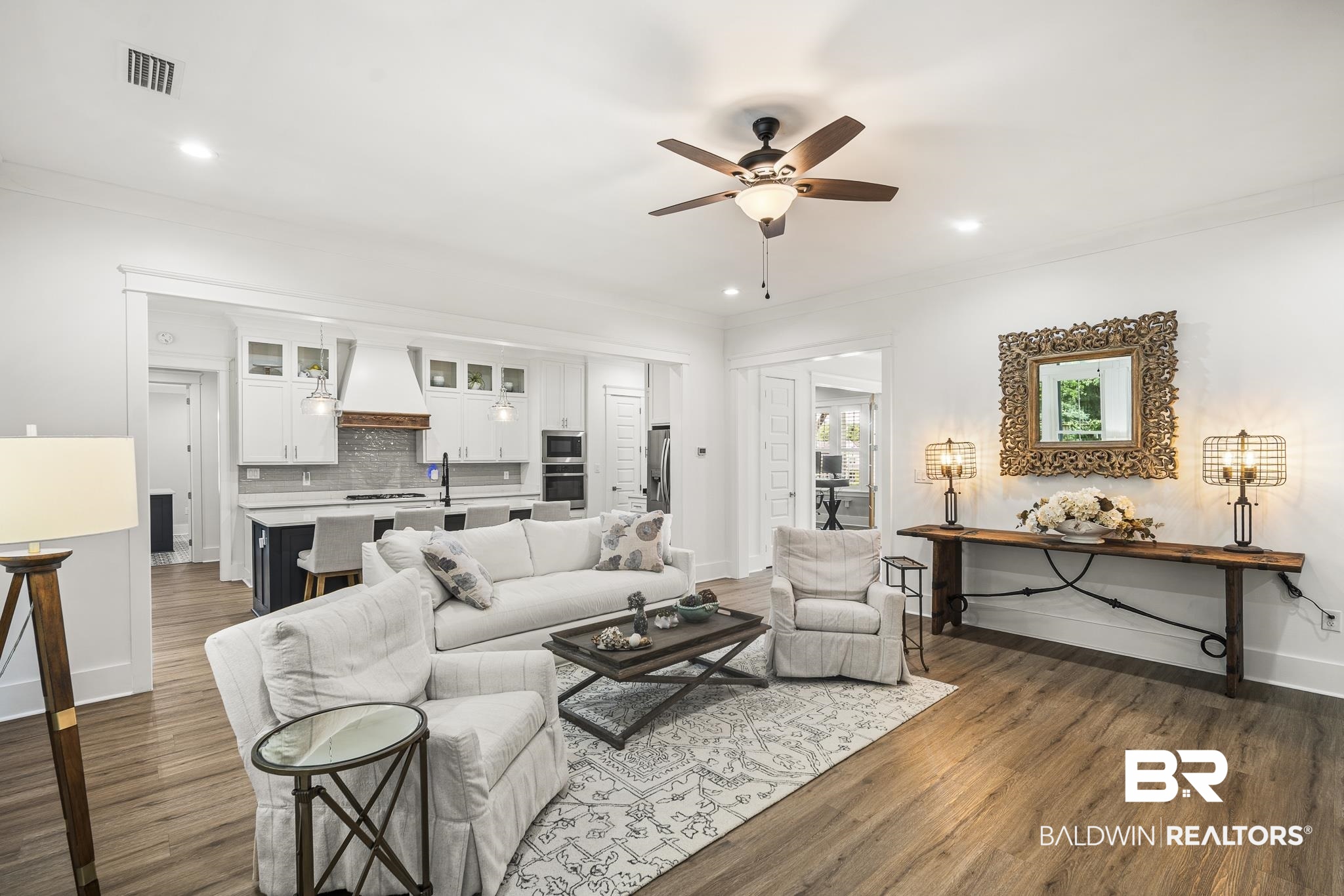 21702 Pillars Street Fairhope, AL 36532 - Photo 9 of 54 Open-concept living space with wood-finish flooring, a ceiling fan, recessed lighting, and a white color palette