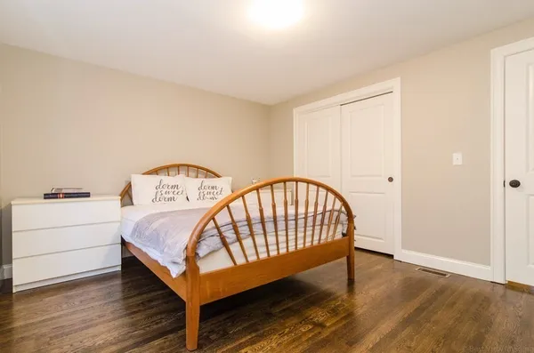 a bedroom with a bed and a table