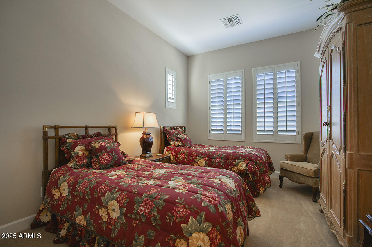 9190 East Hoverland Road Scottsdale, AZ 85255 - Photo 20 of 35 a bedroom with a bed and a window
