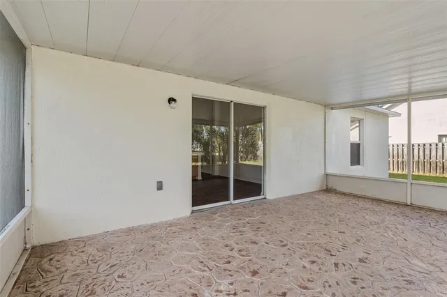 a view of empty room with floor to ceiling window