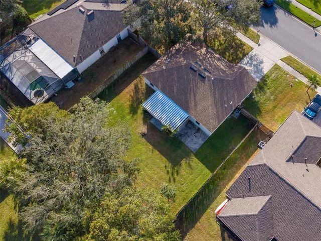 an aerial view of a house with a yard