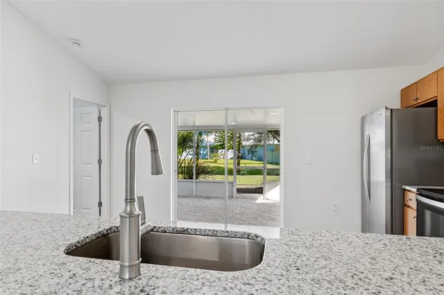 a kitchen with a refrigerator and a sink