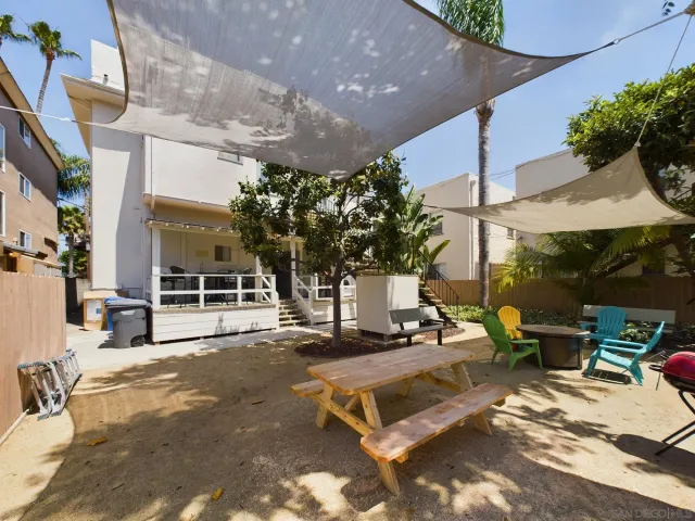 a view of a patio with table and chairs potted plants with wooden floor
