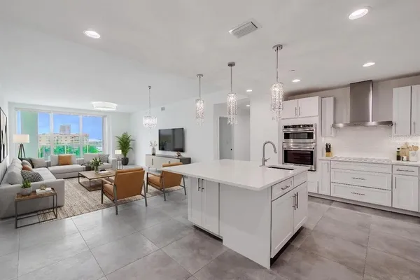 a kitchen with white cabinets stainless steel appliances and sink