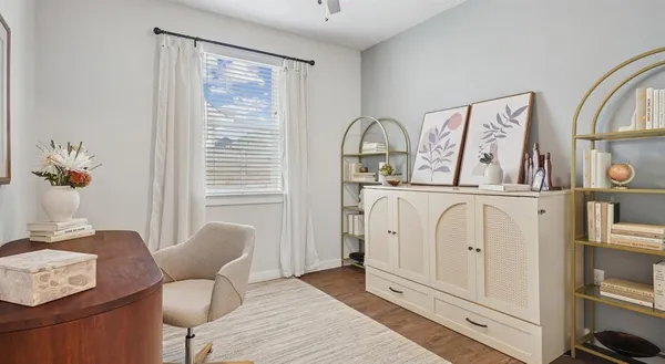 a living room with furniture a window and flowerpot
