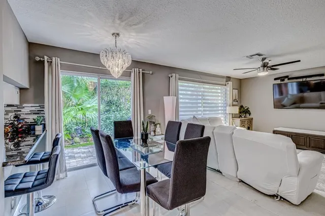 a dining room with furniture window and outside view