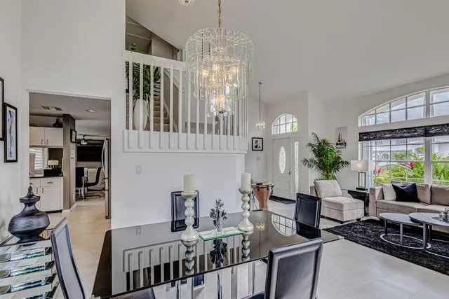 a living room with furniture chandelier and a dining table