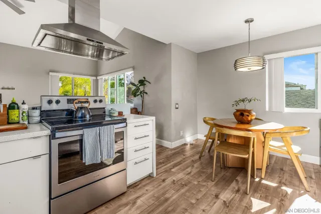 a dining table chairs and a potted plant