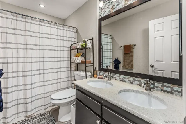 a view of a livingroom with workspace and a window