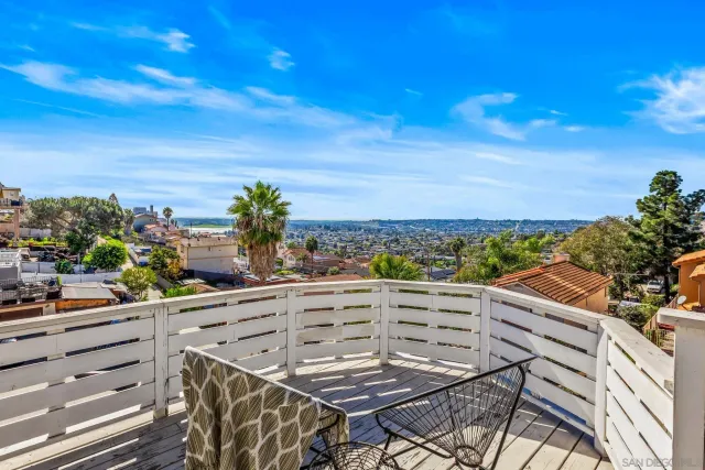 a view of a balcony with wooden fence and floor