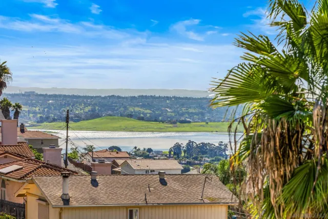 a kitchen with a refrigerator a sink and cabinets