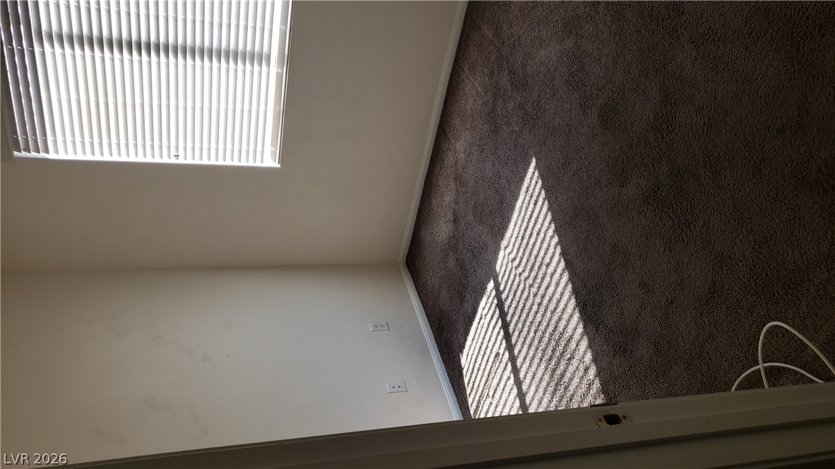 9112 Manalang Road Las Vegas, NV 89123 - Photo 18 of 50 Well-lit room with plush carpeting offers a versatile space, ideal for a quiet study or cozy sleeping quarters.